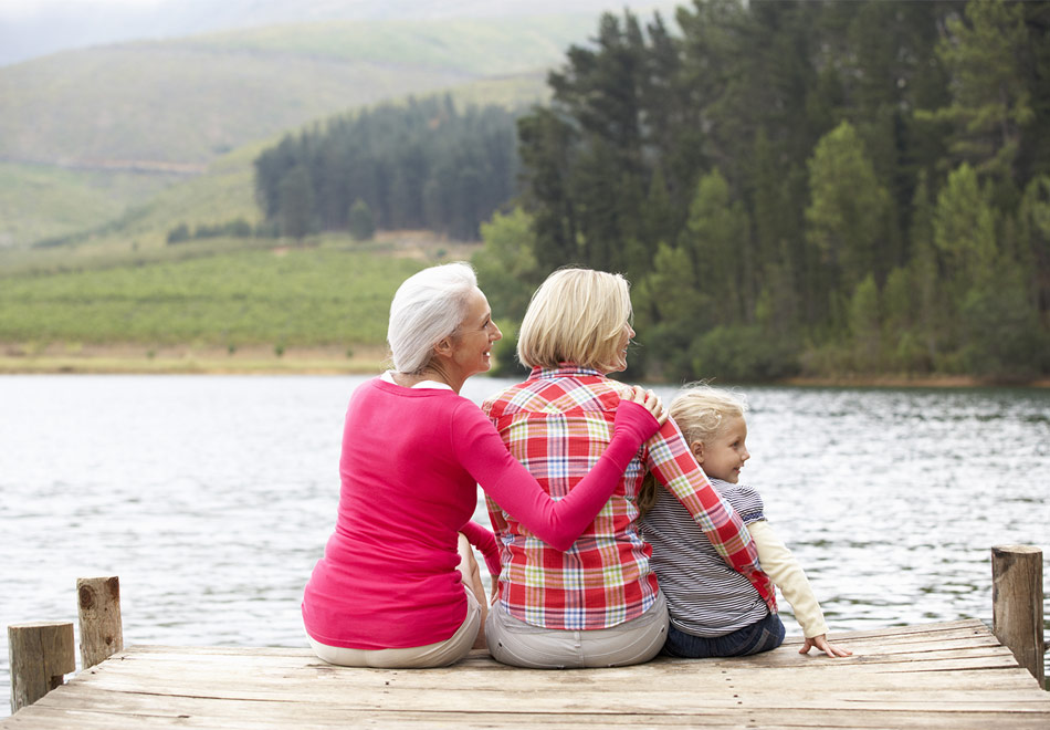 3 generations of women sitting on the dock