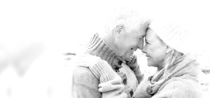 Cute old couple with their foreheads touching - black and white photo
